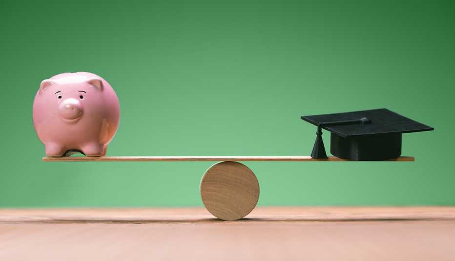 a design showing a piggy bank balancing with a graduation cap over a green field