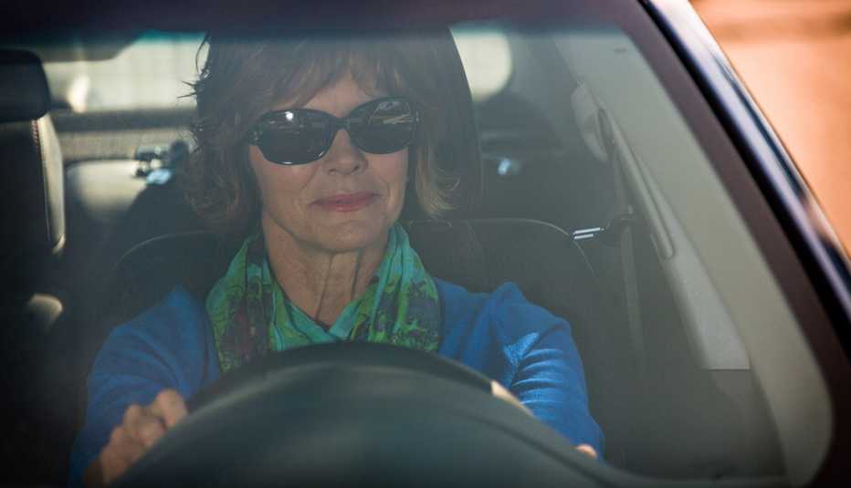 Mature Woman Wearing Sunglasses Driving Car, Stay Sharp, AARP Driver Safety