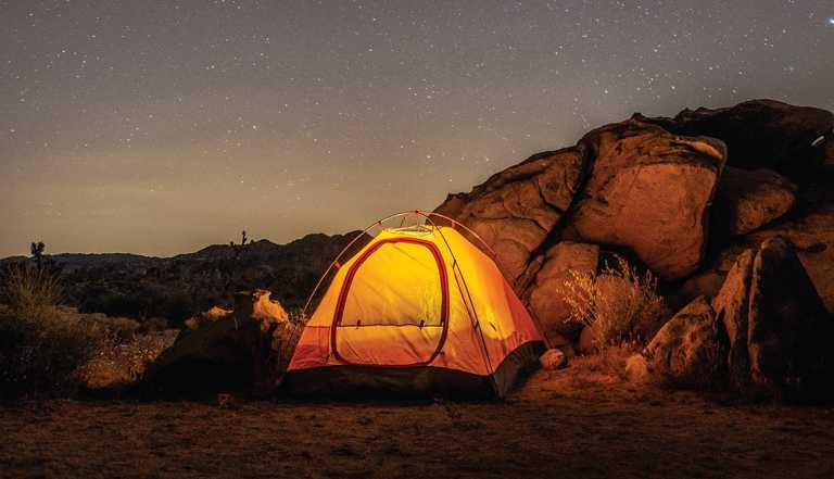 a lit tent within Joshua Tree National Park