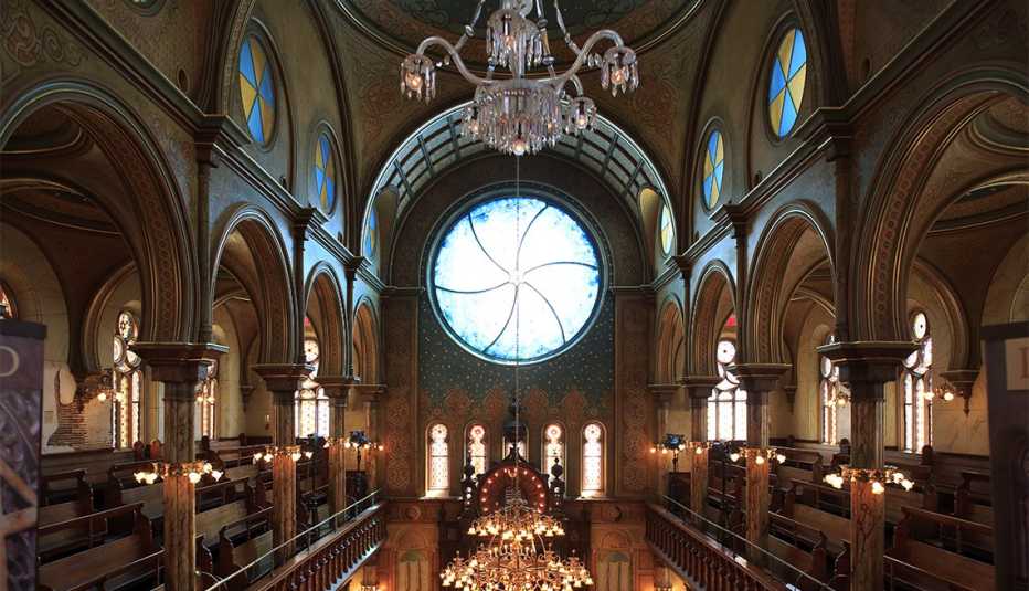 the interior of eldridge street synagogue in new york city is lit up on a sunny day