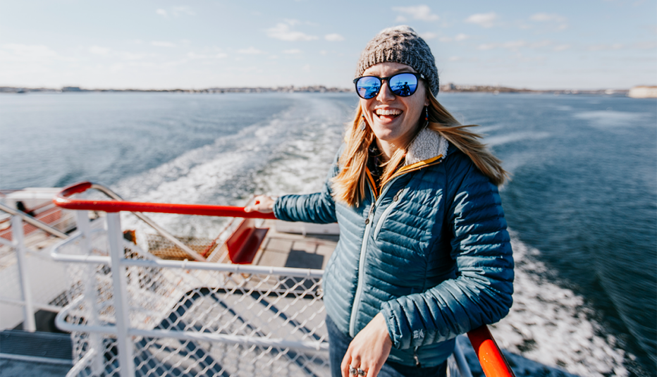 A woman riding a ferry out of Portland, Maine