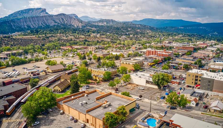 an aerial view of durango colorado with clouds hovering over mountains in the background