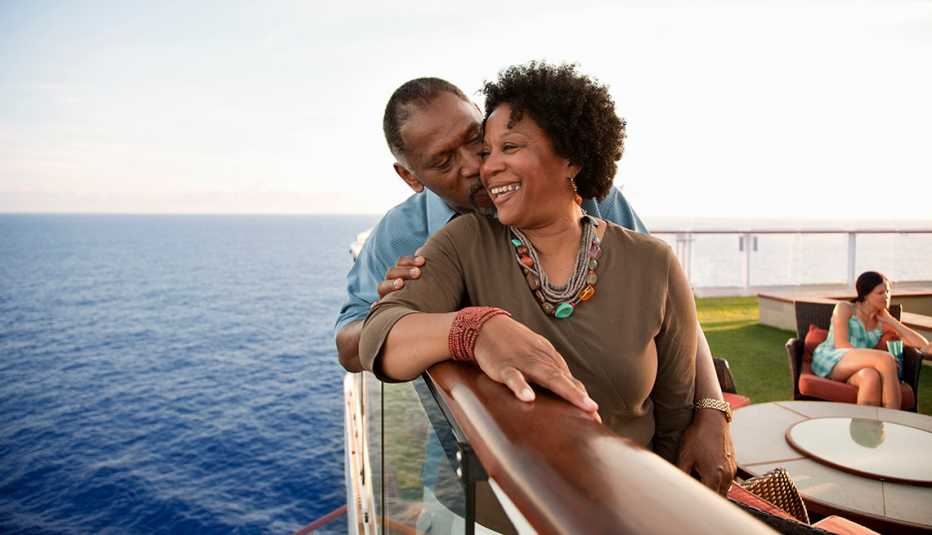 African American Couple Snuggle, Railing of Cruise Ship, Strategies for Scoring Last-Minute Travel Deals