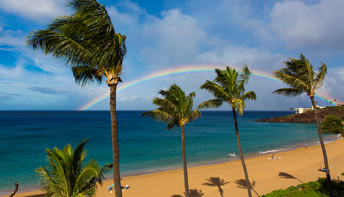 A perfect rainbow on Kaanapali Beach, Maui, Hawaii, forming over Black Rock and into the beautiful sea.