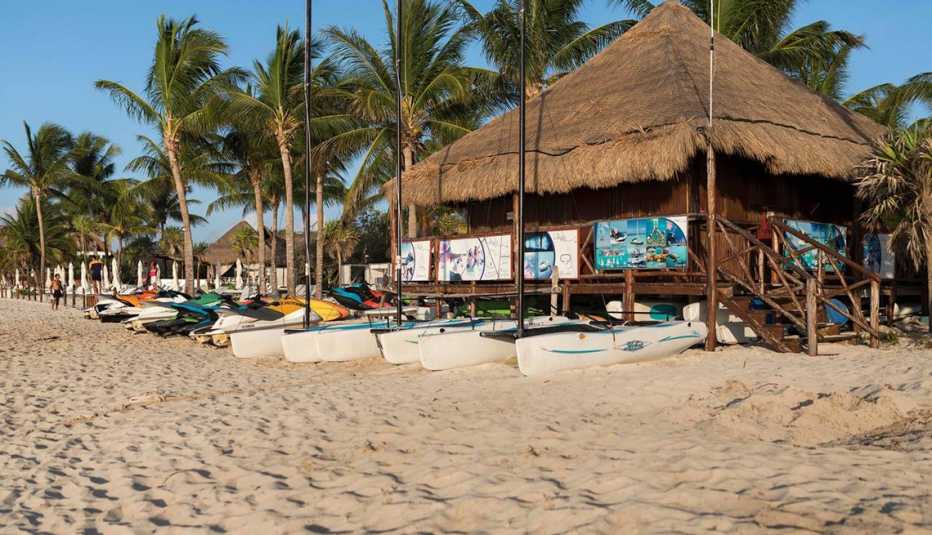Surf shack or sports pavillion on the beach at Playa Del Carmen hiring canoes and jet skis and selling excursions 