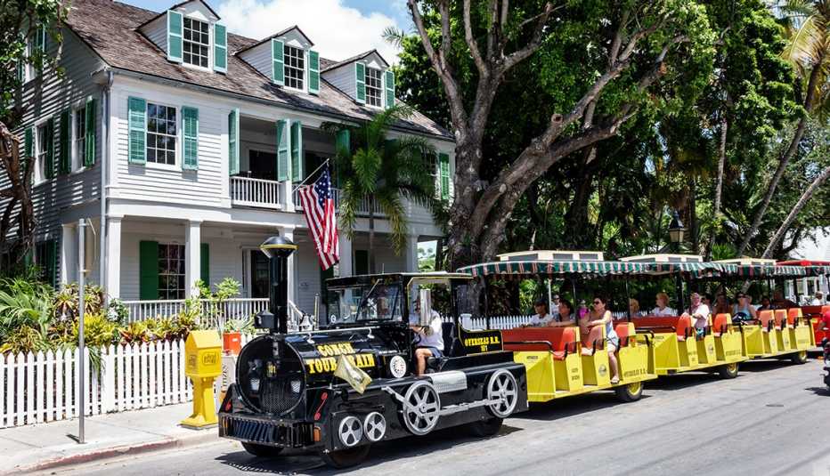 Old Town Audubon House and Tropical Gardens with a black train out front in Key West Florida