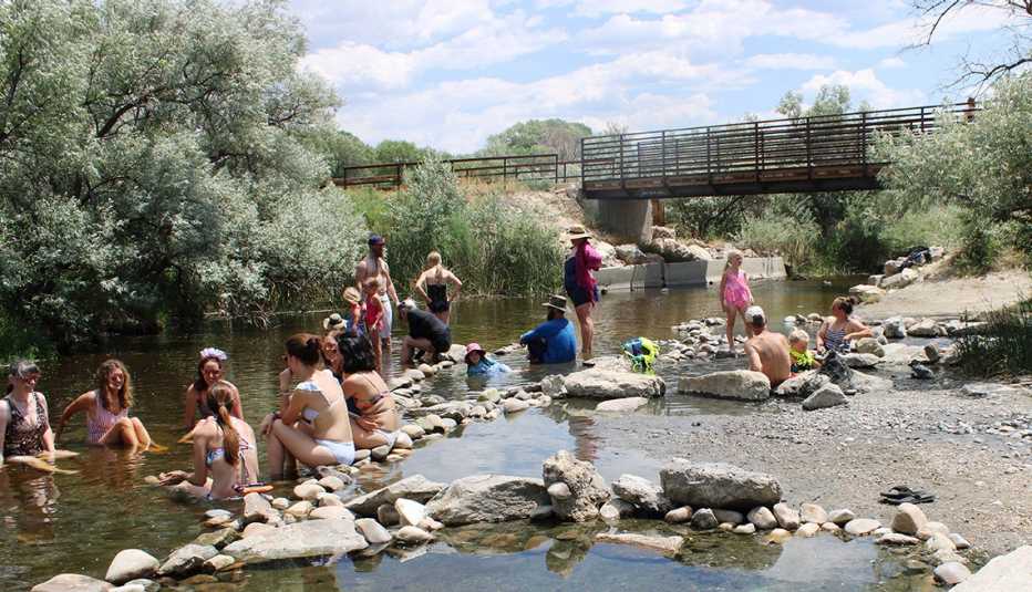 people in bathing suits enjoying hot springs in saratoga wyoming
