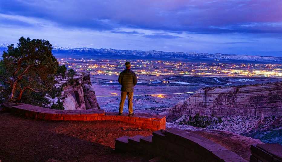 man overlooking grand junction colorado at twilight