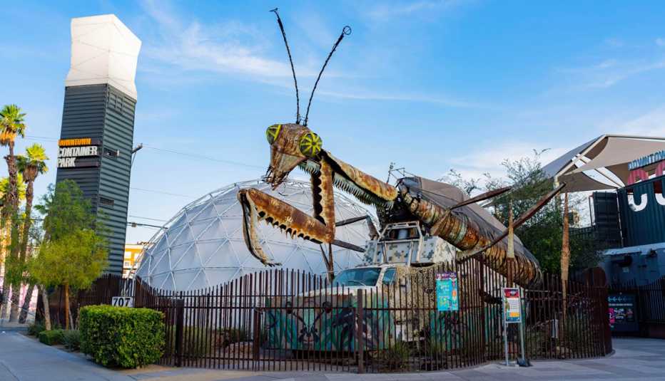 a giant metal praying mantis looms over the container park in las vegas nevada