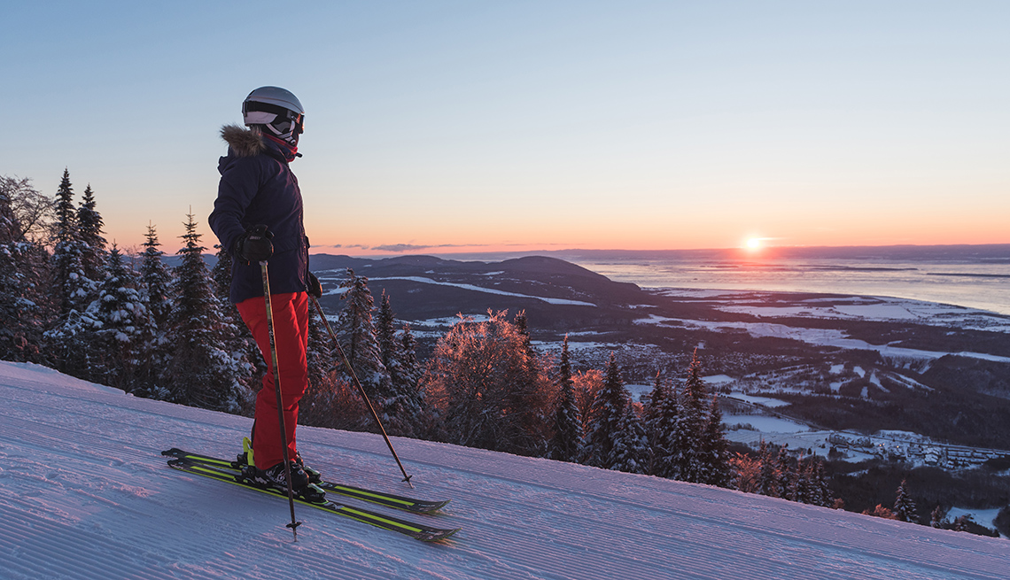 a skier atop a mountain at dusk in Beaupre, Quebec