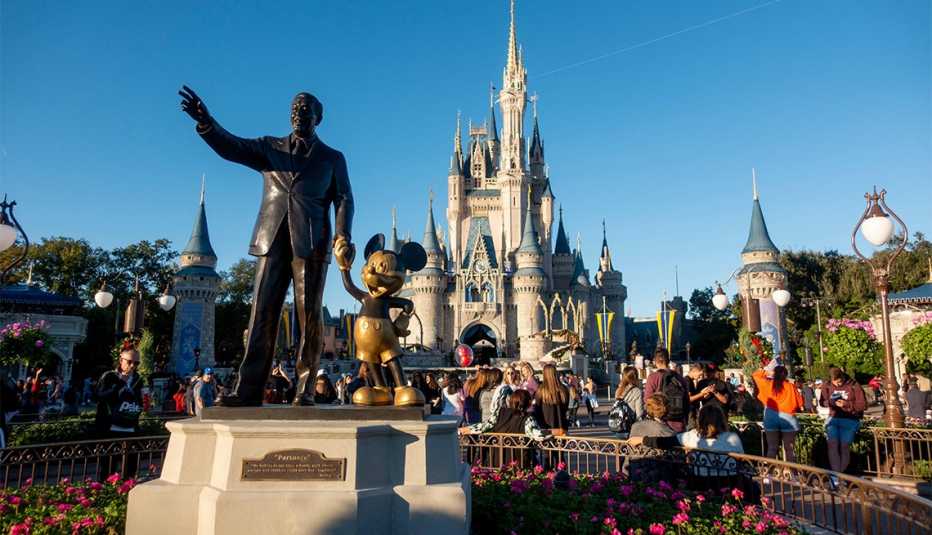 Walt Disney and Mickey Mouse statue in front of Cinderella's Castle in Orlando, Florida