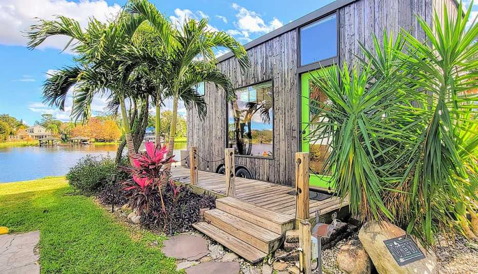 The exterior of an Orlando Lakefront tiny home with palm trees