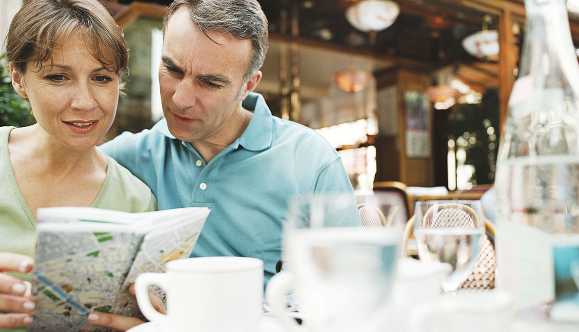 Middle Aged Caucasian Couple Look At Map At Restaurant, How To Save Safe While Traveling