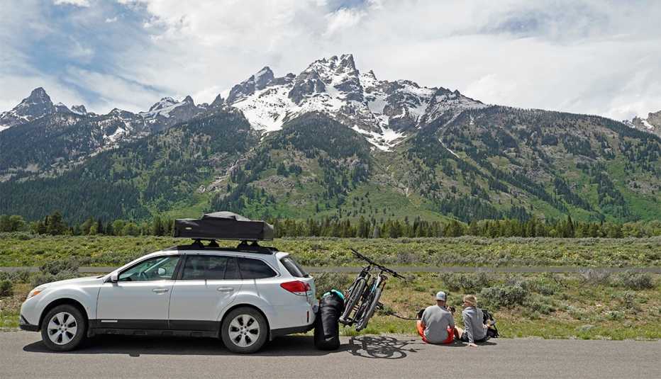 A couple parks on the side of the road to have lunch in Grand Teton National Park 