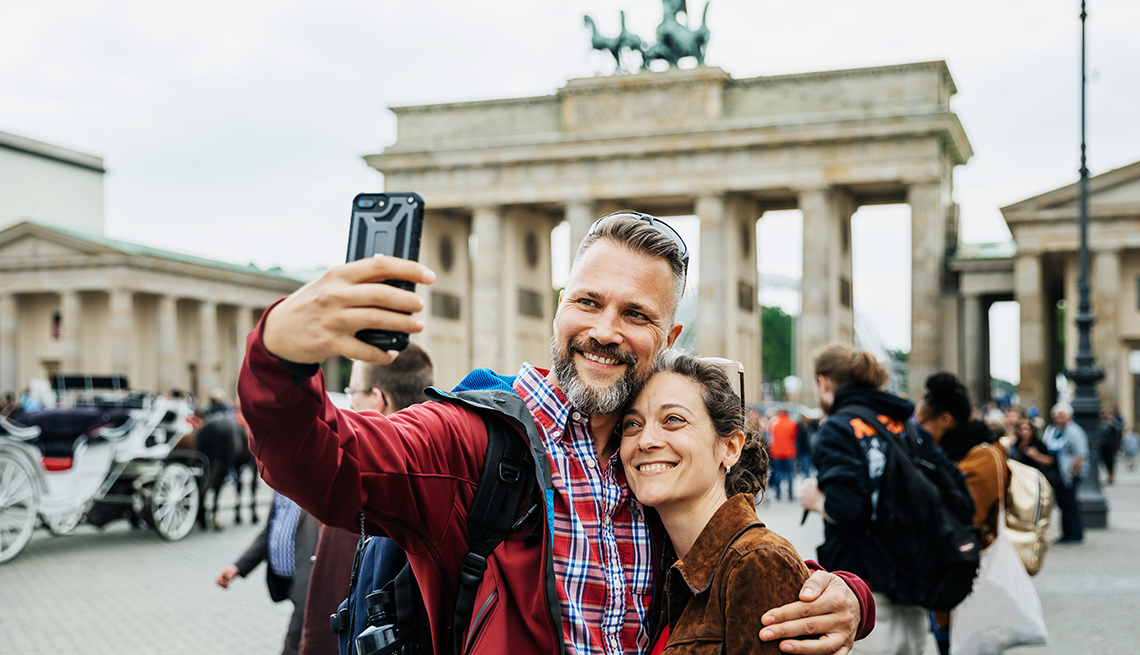 A smiling couple takes a selfie while in Berlin