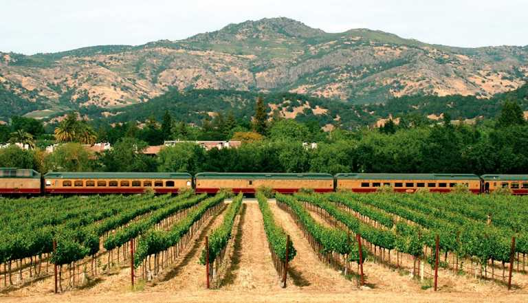 the napa valley wine train driving past vineyards and mountains in napa valley california