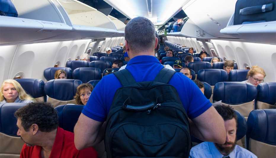 man boarding a crowded plane