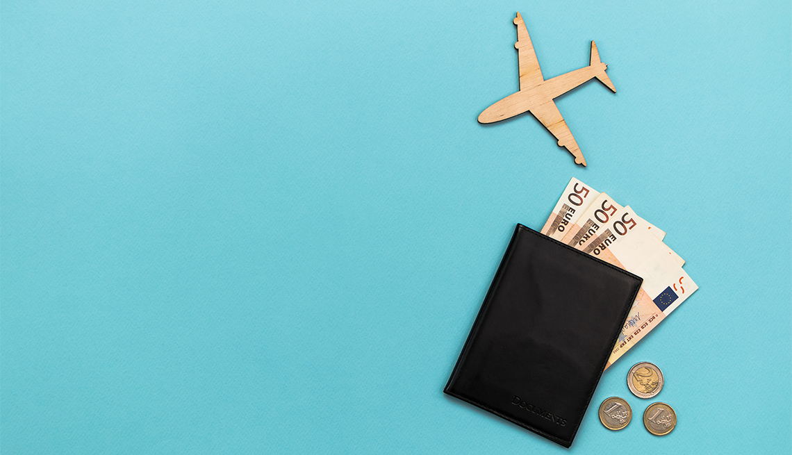 wooden airplane, Euros and a passport on a blue background