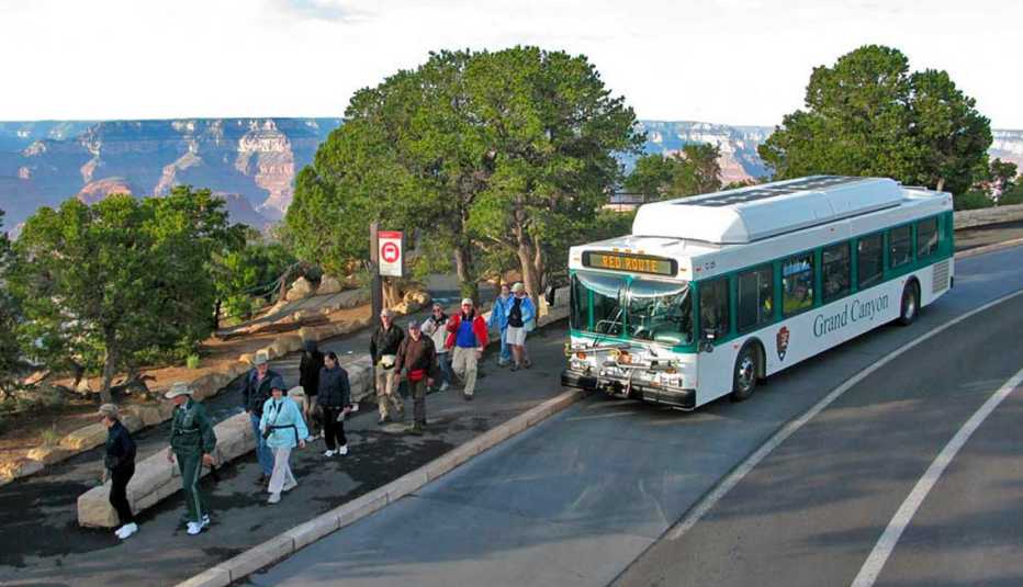 a bus letting off visitors at the grand canyon national park in arizona