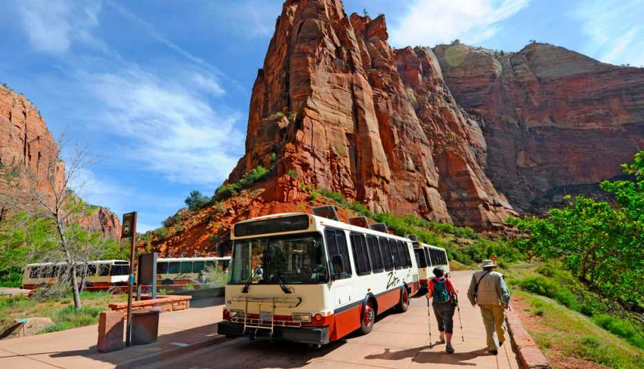 hikers walking by a bus in mount zion national park utah