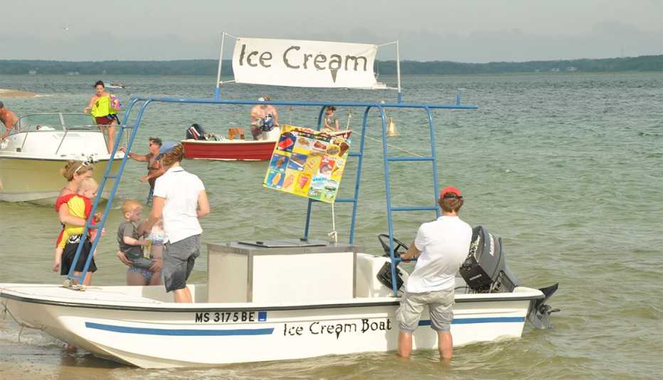 families purchase ice cream from a boat on shore in Cape Cod