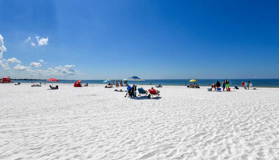 people lounging on the white sand of siesta beach in florida