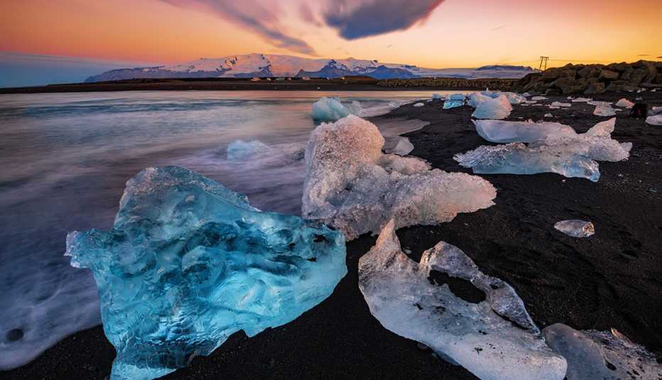 ice rocks on the black sand of diamond beach in iceland