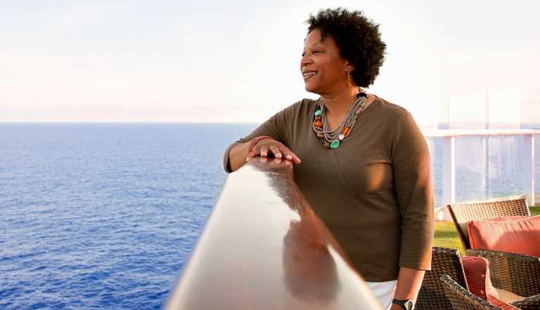a woman on a cruise ship looking out at the water