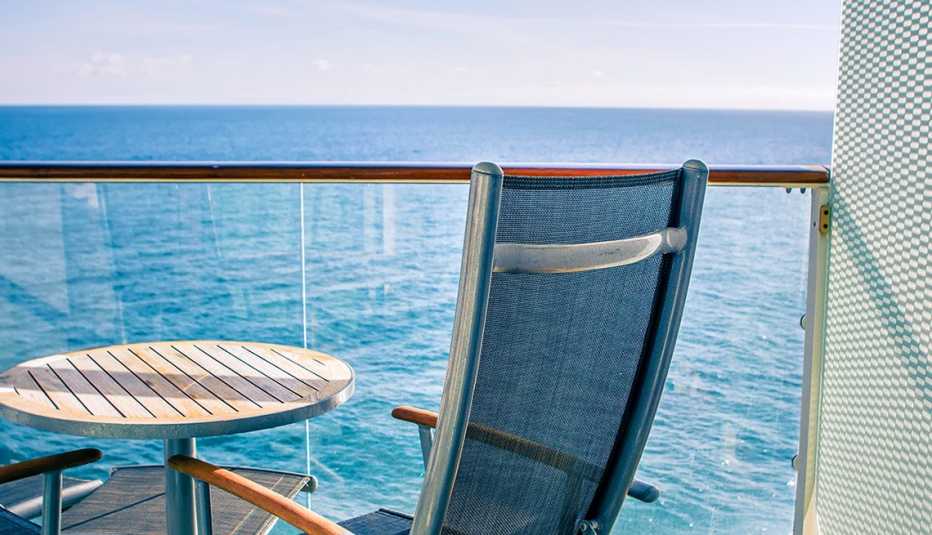 Close up of chair and table on private balcony on cruise ship.