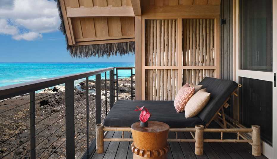 a comfy black lounge chair on a balcony at Kona Village, A Rosewood Resort on Hawaii's Big Island