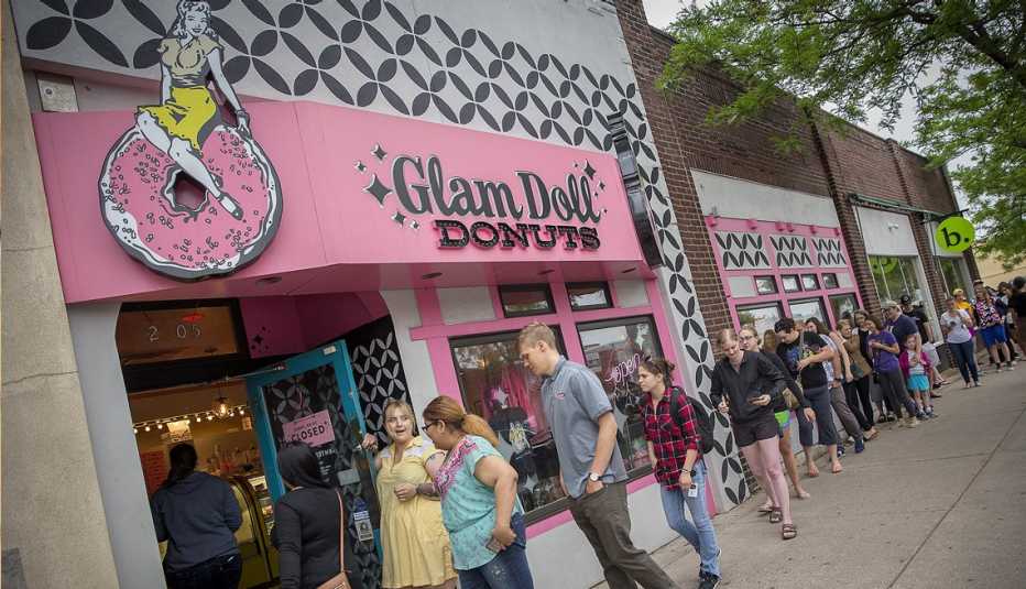 people lined up outside of glam doll donuts in minneapolis