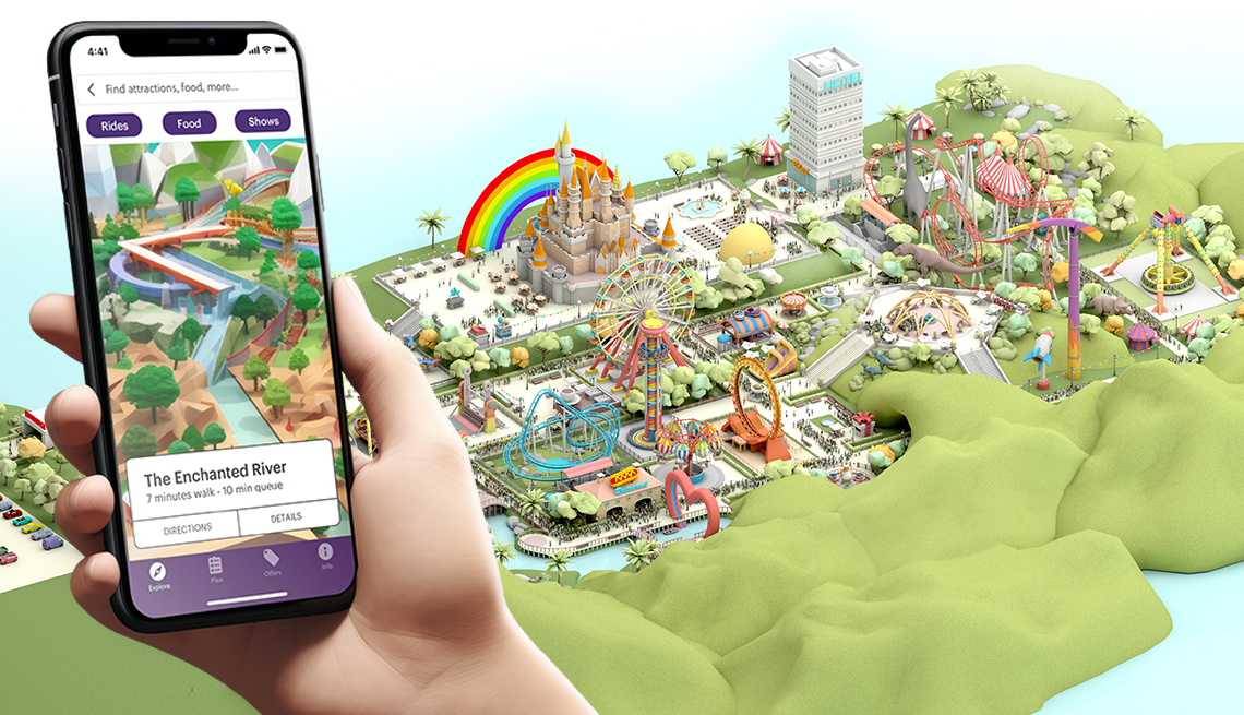 hand holding a mobile phone showing an amusement park app that matches up to a rendering of the park in the background