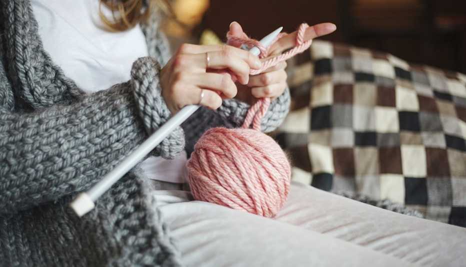 a woman knitting with yarn