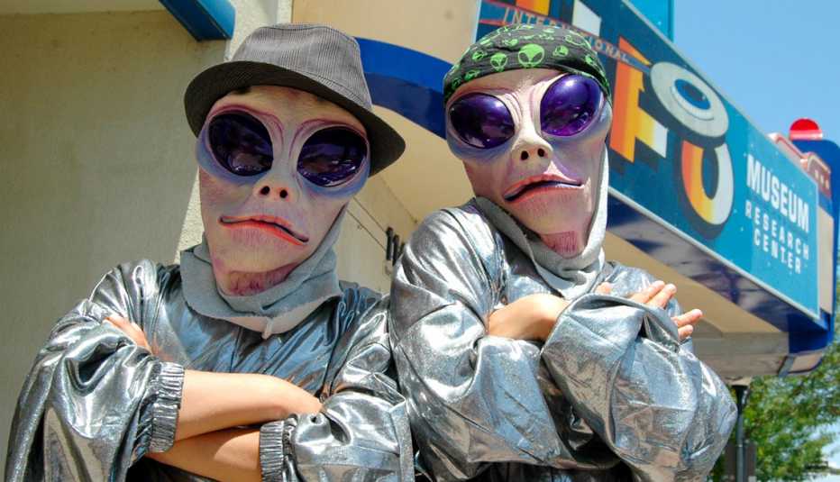alien cosplayers pose in front of the u f o museum in roswell new mexico during the u f o festival