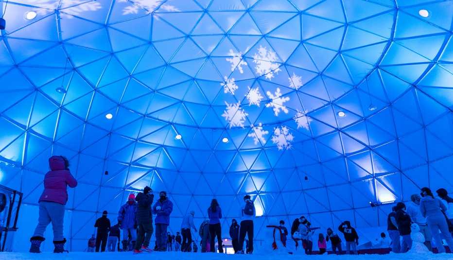 people standing inside the Arctic Igloo which has over 100 tons of artificially made snow.