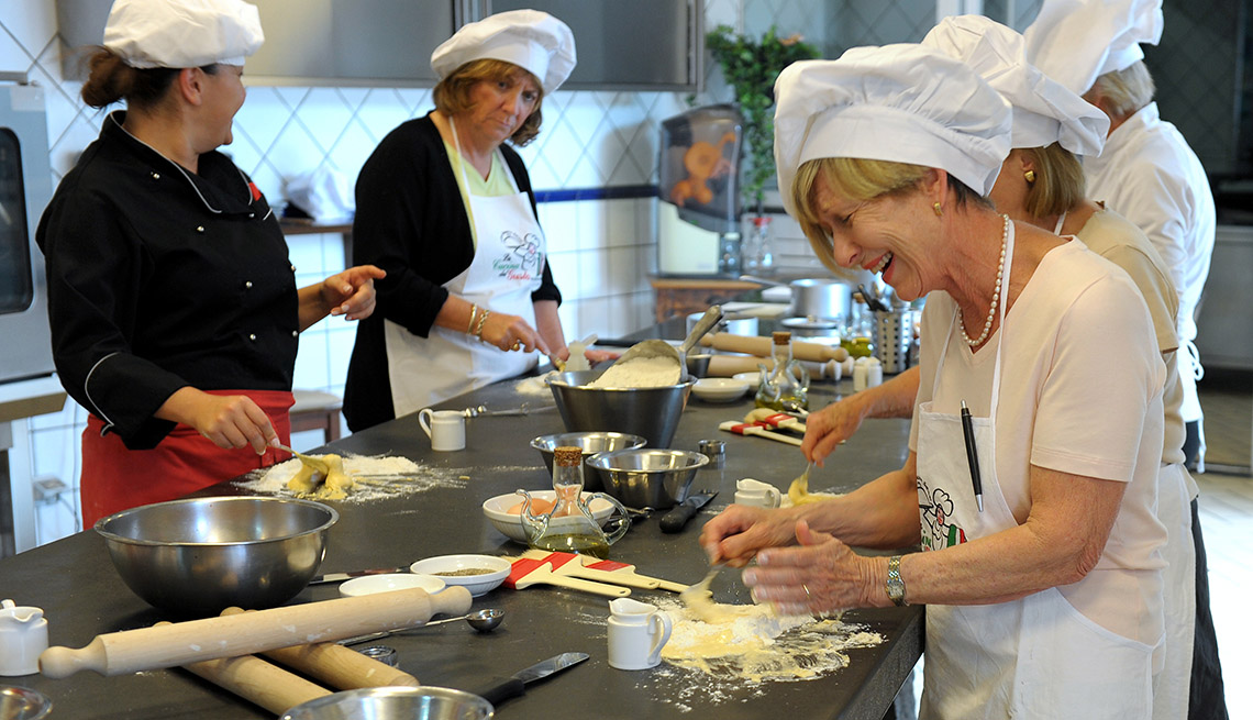 Smiling Middle Aged Caucasian Woman Takes A Cooking Class, Culinary Travel