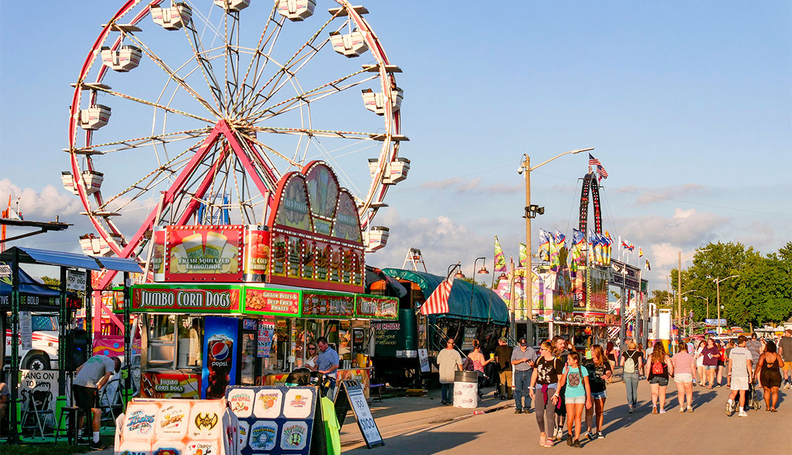 people walking down the midway of the illinois state fair