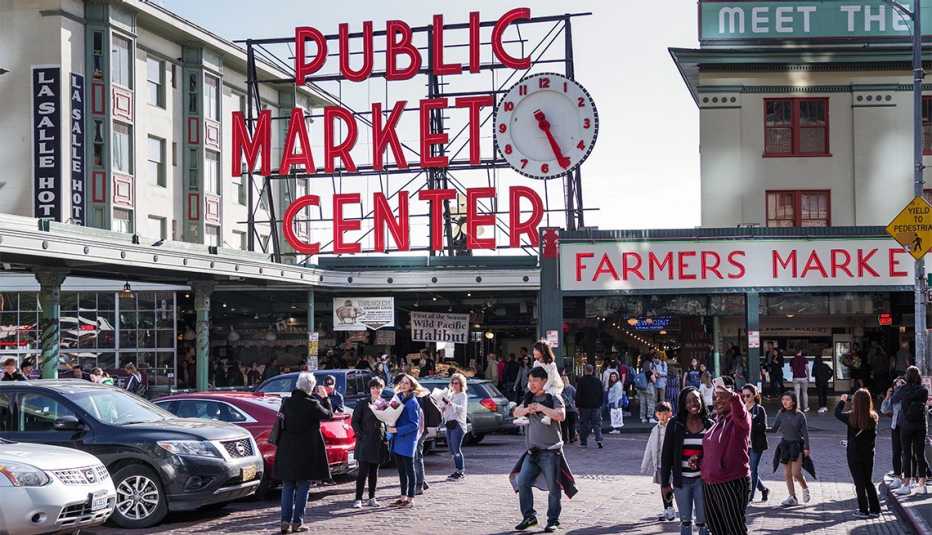 people standing outside the famous Pike Place Market in Seattle