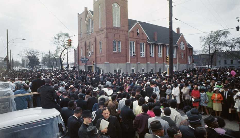Thousands of funeral marchers gathered outside Ebenezer Baptist Church prepare to walk five miles to Morehouse College where another service for the slain Dr. Martin Luther King, Jr., will be held.