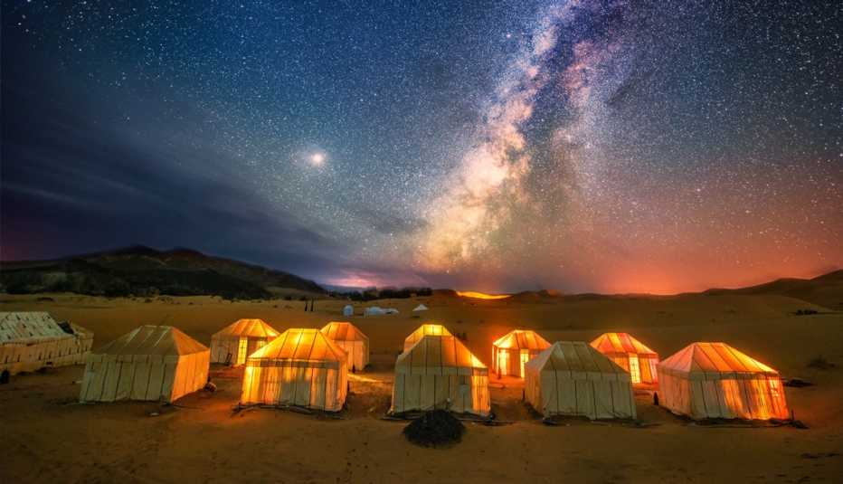 tents at night under the milky way in the sahara desert in morocco