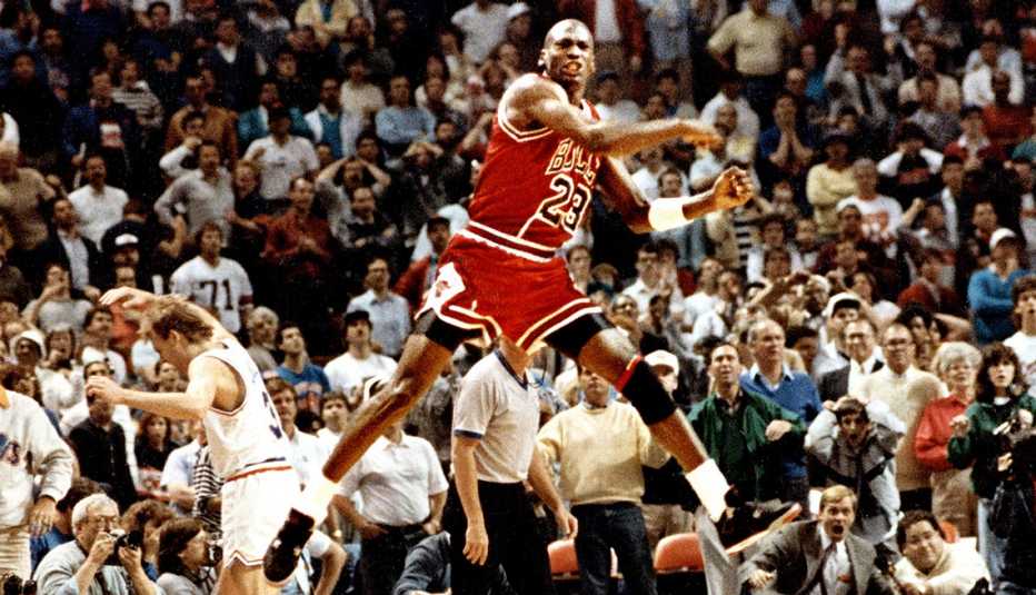 Michael Jordan of the Chicago Bulls jumps in celebration after making the game-winning shot over Cleveland's Craig Ehlo in Game 5 of the NBA playoffs on May 7 1989 in Cleveland Ohio