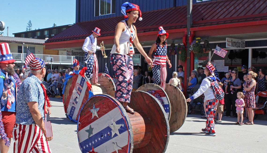 young parade participants dressed in patriotic gear rolling on wheels