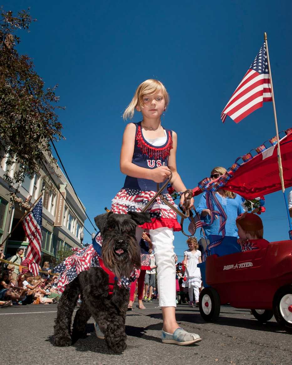 a young girl and her dog at a july 4 event in bend oregon