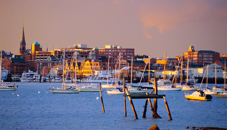 boats in the harbor at sunset outside portland maine
