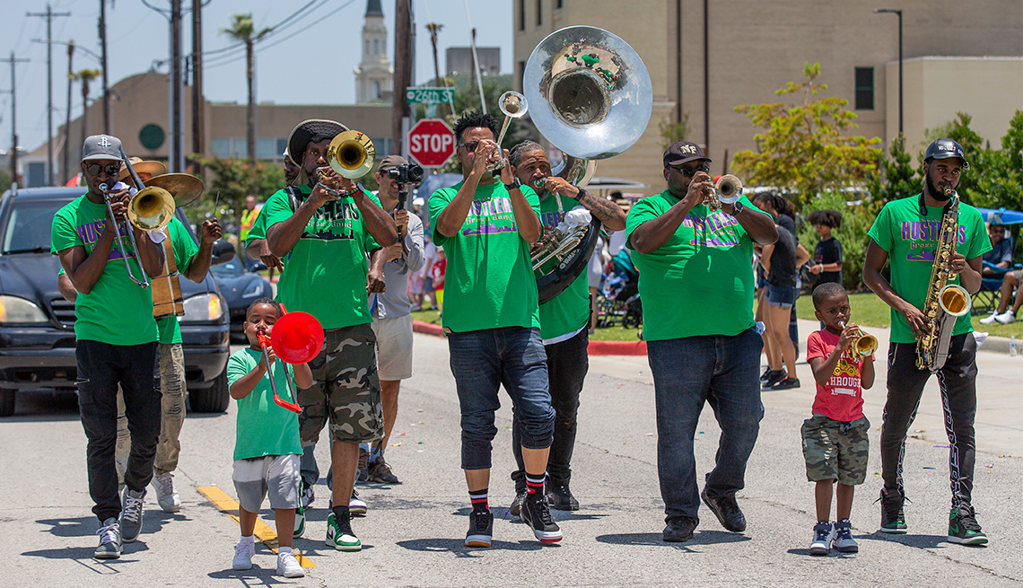a band playing music marching in the galveston texas juneteenth parade