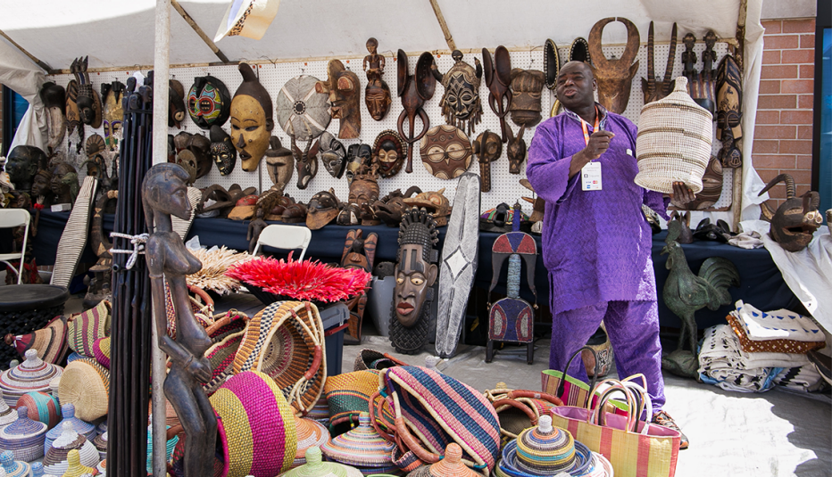 a vendor selling carved art and baskets at milwaukee juneteenth in wisconsin
