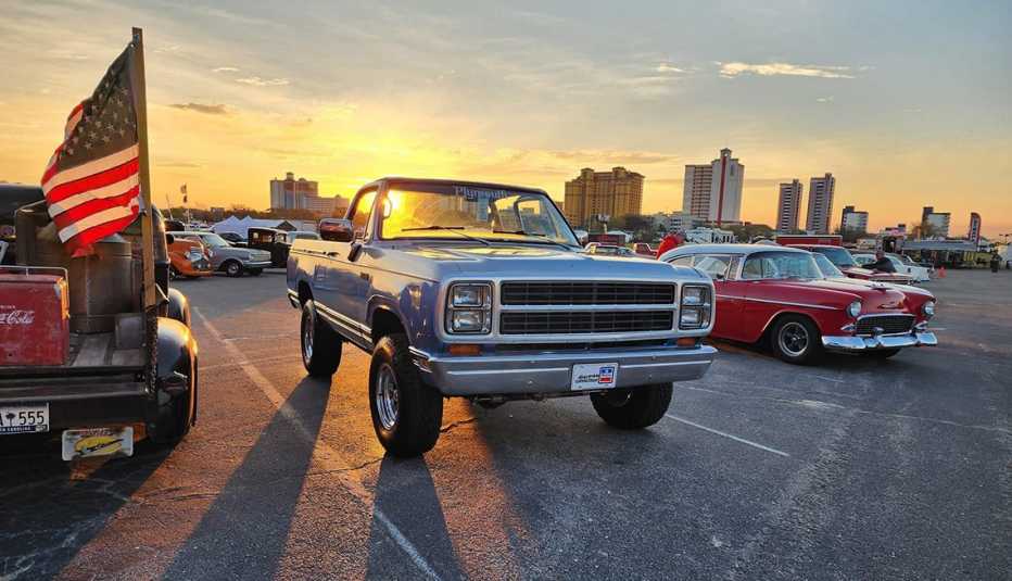 classic trucks and cars lit up by the sunset in the parking lot of myrtle square mall in myrtle beach south carolina