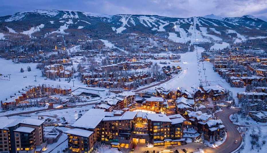 an aerial view of brightly lit snowmass village