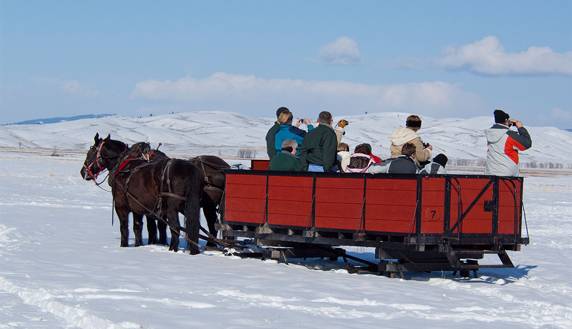 people aboard a horse-drawn sleigh at the National Elk Refuge, Wyoming