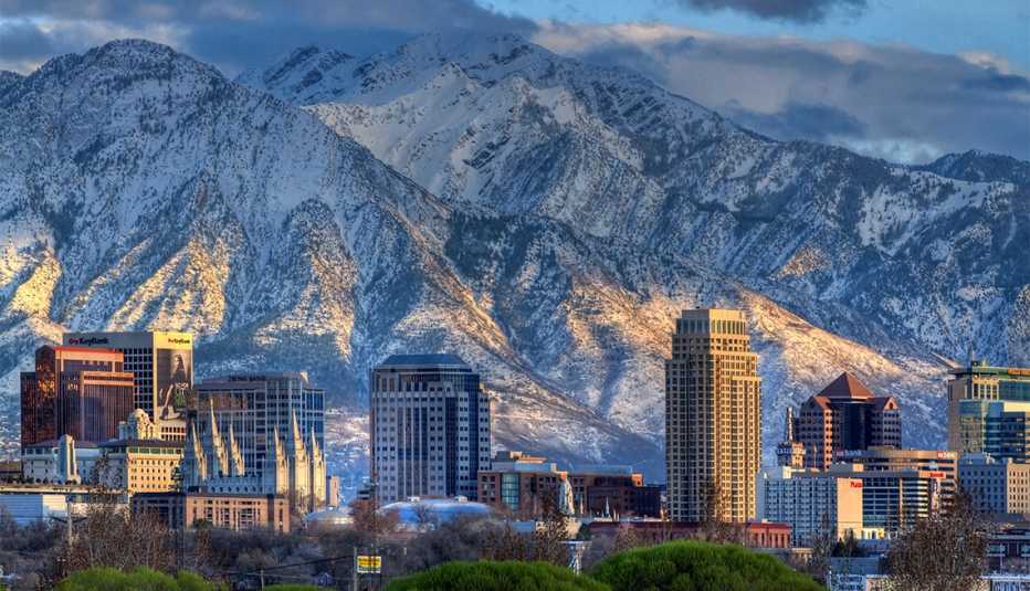 Panoramic view of the downtown Salt Lake City skyline in early spring with the snow capped Wasatch Mountains in the background